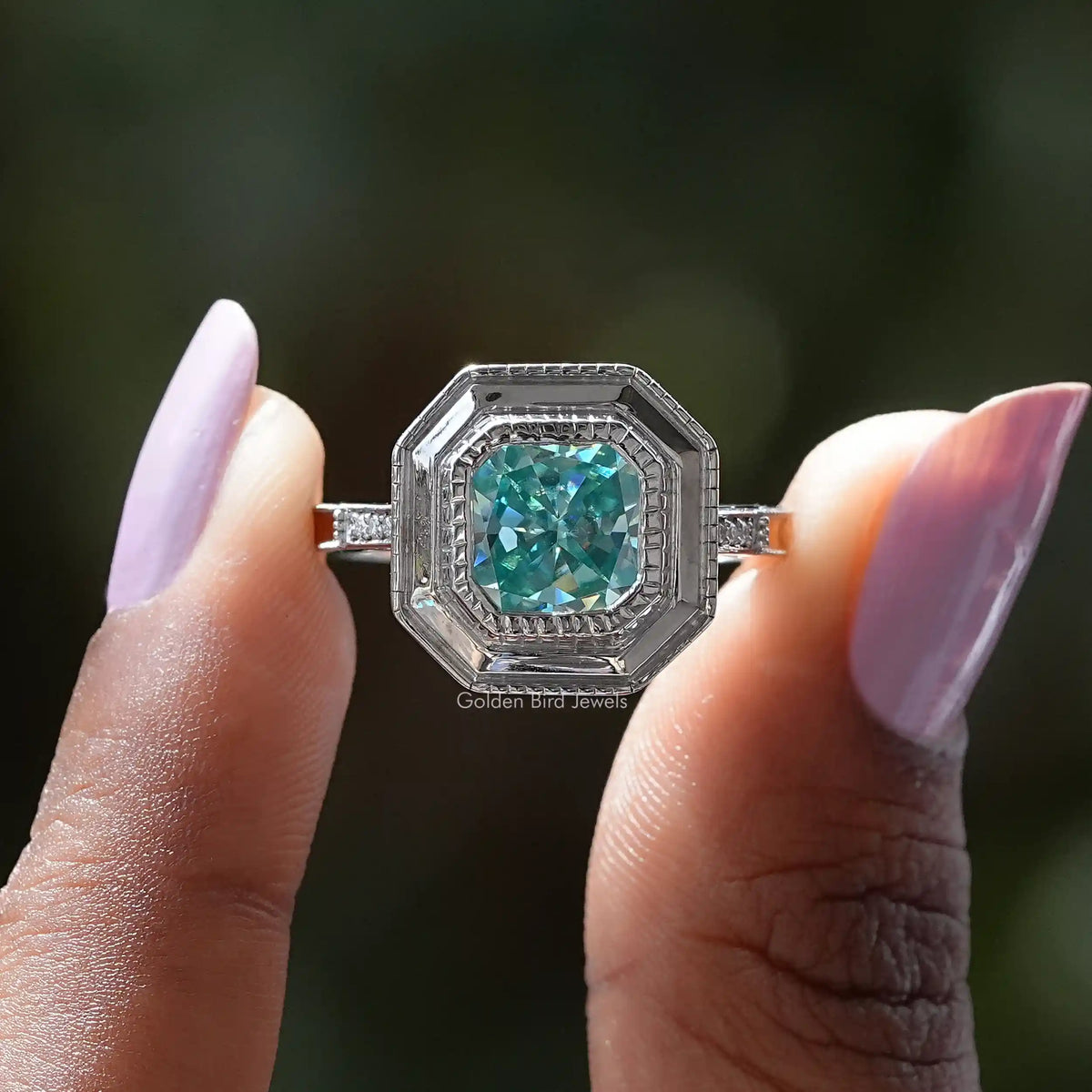Two fingers holding the Radiant Cut Moissanite Milgrain Engagement Ring