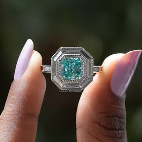 Two fingers holding the Radiant Cut Moissanite Milgrain Engagement Ring