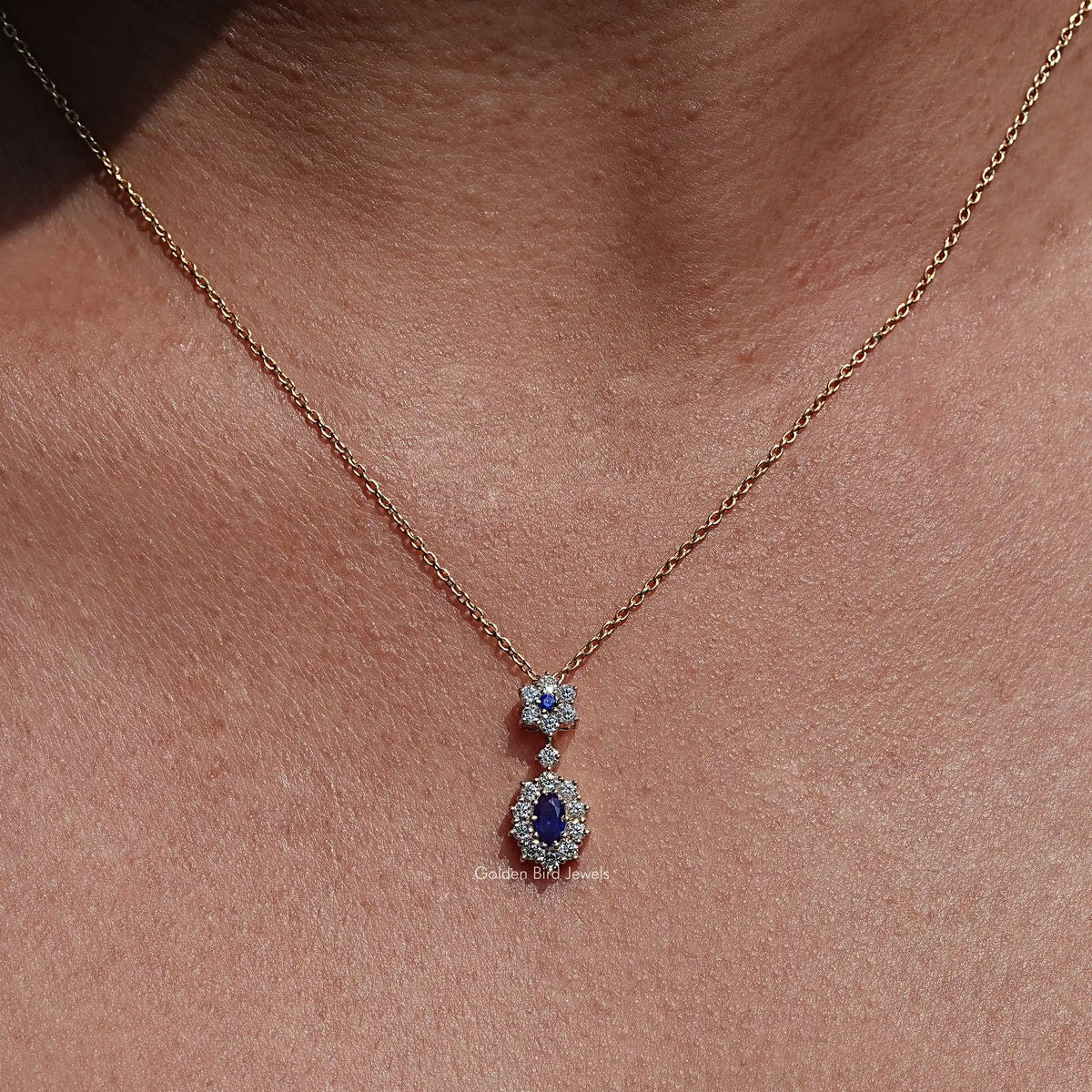 Front view of Blue Sapphire Oval Gemstone Halo Pendant In Women's 