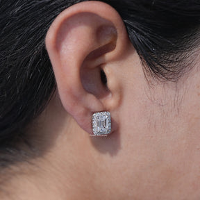 In ear view of emerald cut cluster diamond earrings