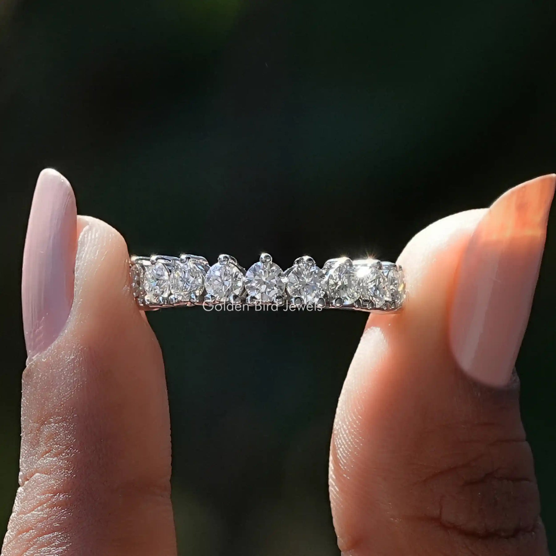 [In finger front view of colorless round cut moissanite wedding band]-[Golden Bird Jewels]