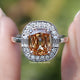 Front view of Criss Cut Cushion Moissanite Halo Engagement Ring in two fingers 
