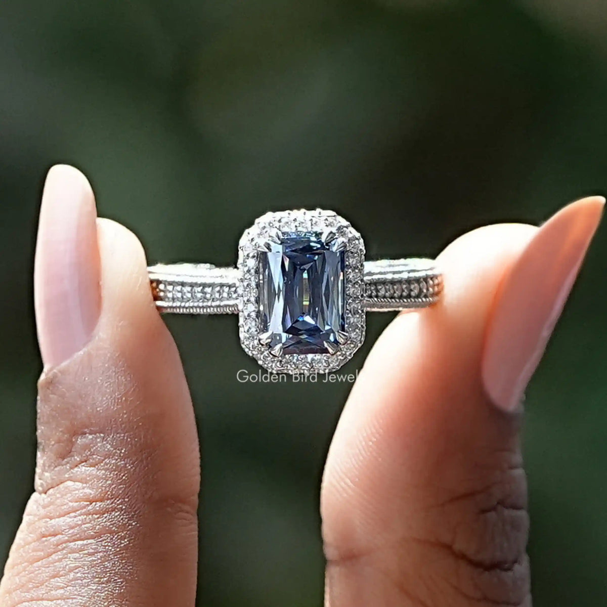 Two fingers holding the Criss Cut Moissanite Wedding Ring