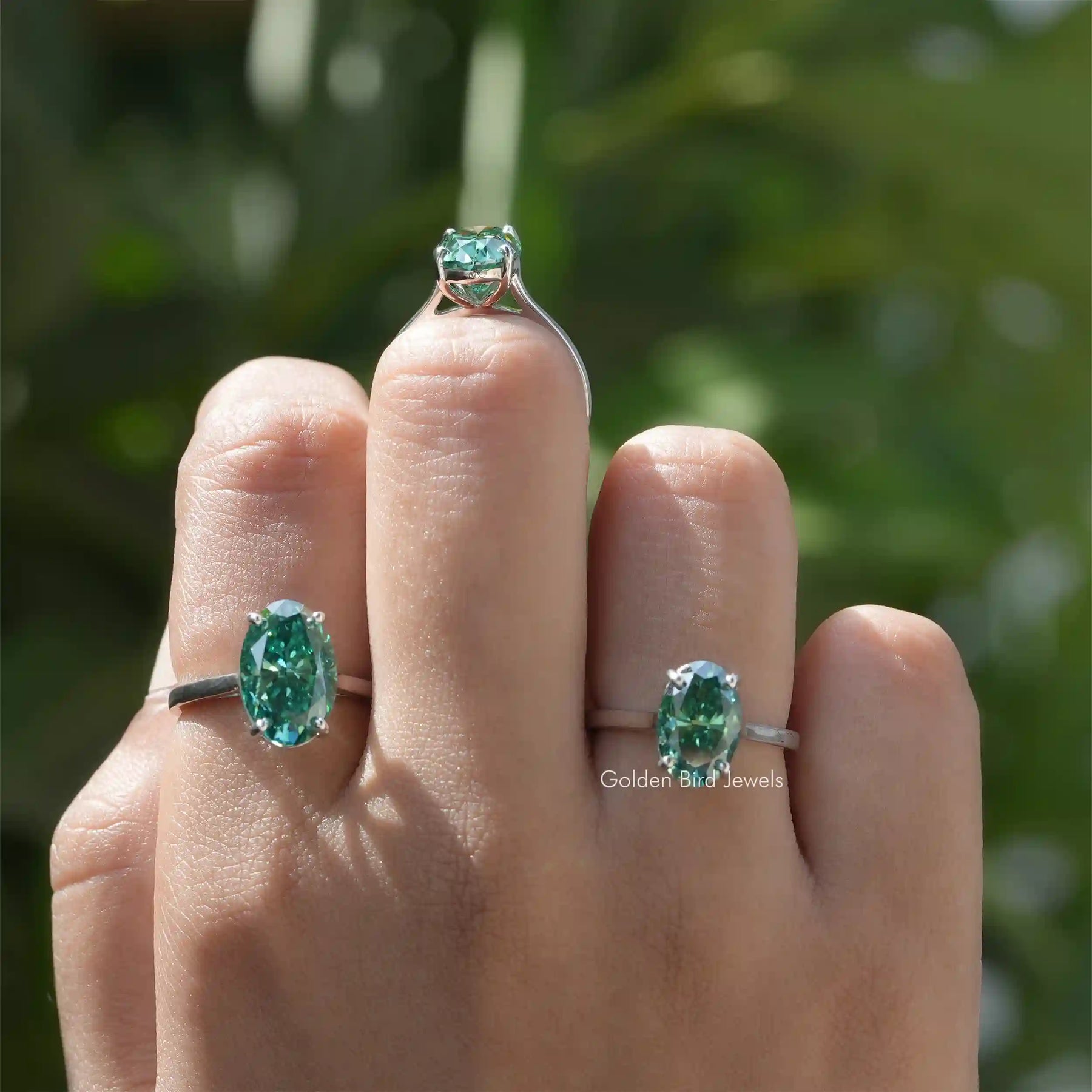 [In finger front view of moissanite oval cut ring set in cathedral setting]-[Golden Bird Jewels]