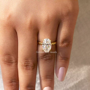 [In finger front view of oval cut moissanite ring set in prong setting]-[Golden Bird Jewels]