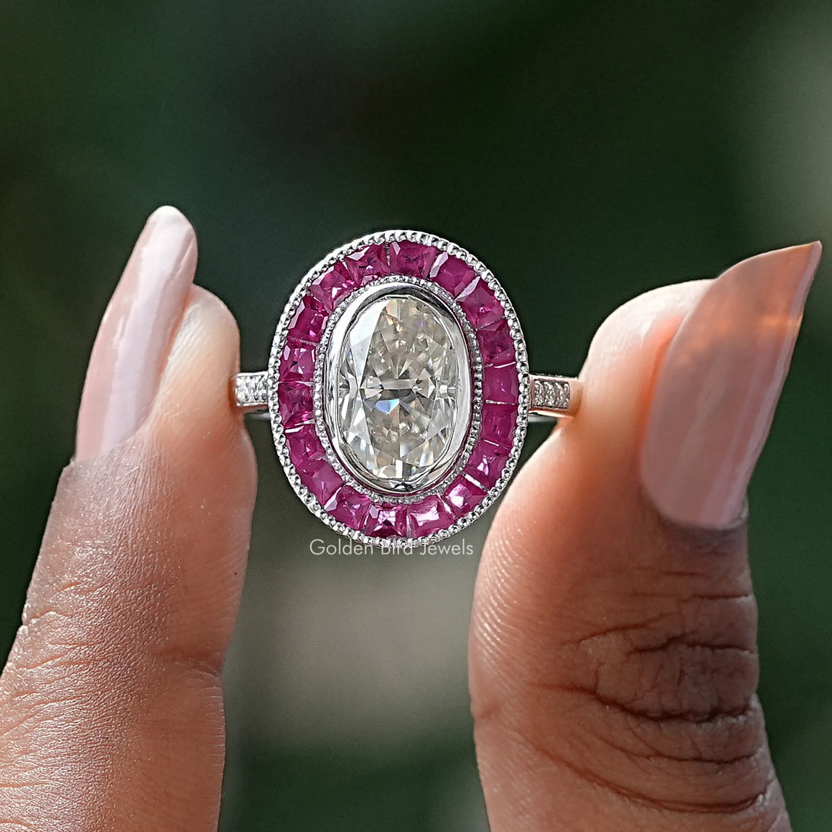Two fingers holding the Ice Oval Moissanite Halo Engagement Ring