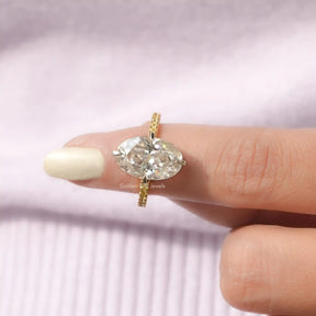 In finger front View of Crushed Ice Oval Cut Ring With Round Cut Stones