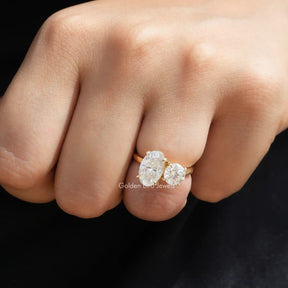 [In finger front view of crushed ice oval and round cut moissanite toi et moi ring]-[Golden Bird Jewels]