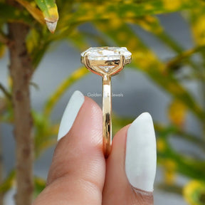 [In two finger side view of oval and round cut yellow gold moissanite ring]-[Golden Bird Jewels]