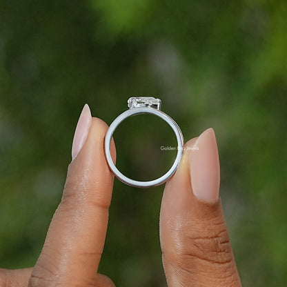 Pear-cut moissanite solitaire engagement ring viewed from the side