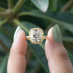[In two finger front view of cushion cut bezel set ring made of 14k yellow gold]-[Golden Bird Jewels]
