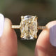[In two finger front view of cushion cut moissanite engagement ring]-[Golden Bird Jewels]