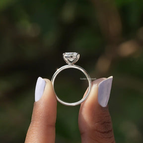 Back View of Cushion Cut Lab Grown Solitaire Ring In two fingers