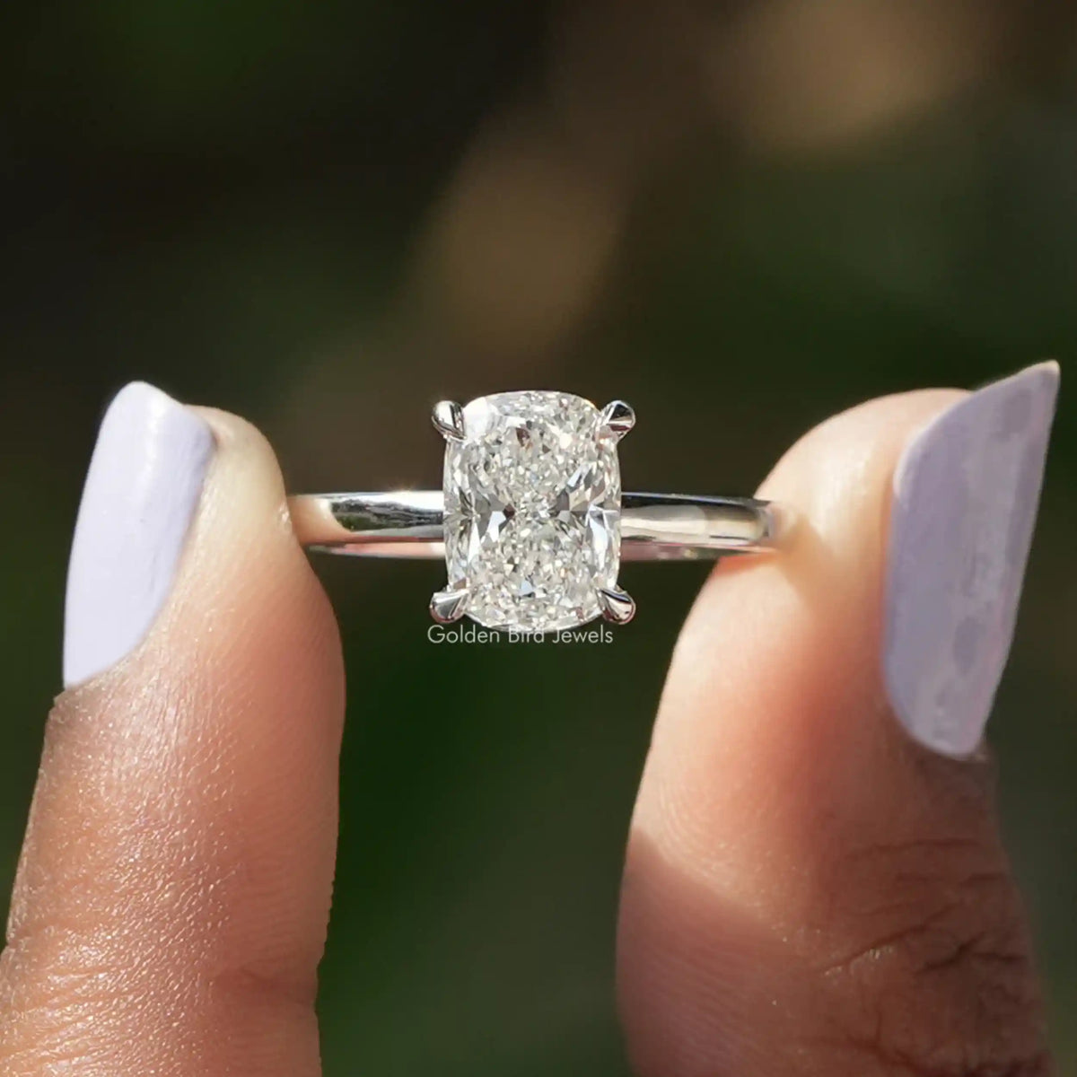 Two fingers holding the Cushion Cut Lab Grown Diamond Solitaire Ring