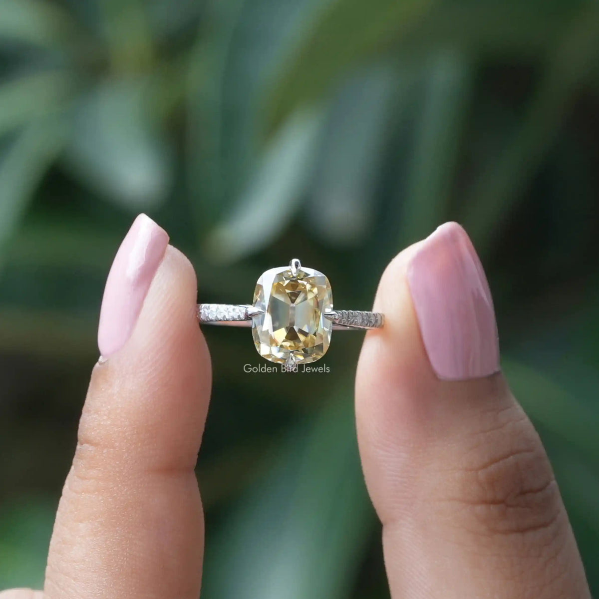 [In finger front view of yellow old mine cushion cut moissanite engagement ring]-[Golden Bird Jewels]
