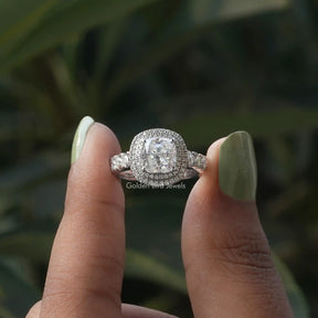 Two fingers holding the Cushion Cut Moissanite Double Halo Moissanite Ring