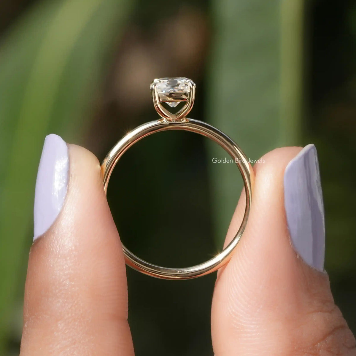 Back View of Cushion Cut Solitaire Moissanite Ring In two fingers