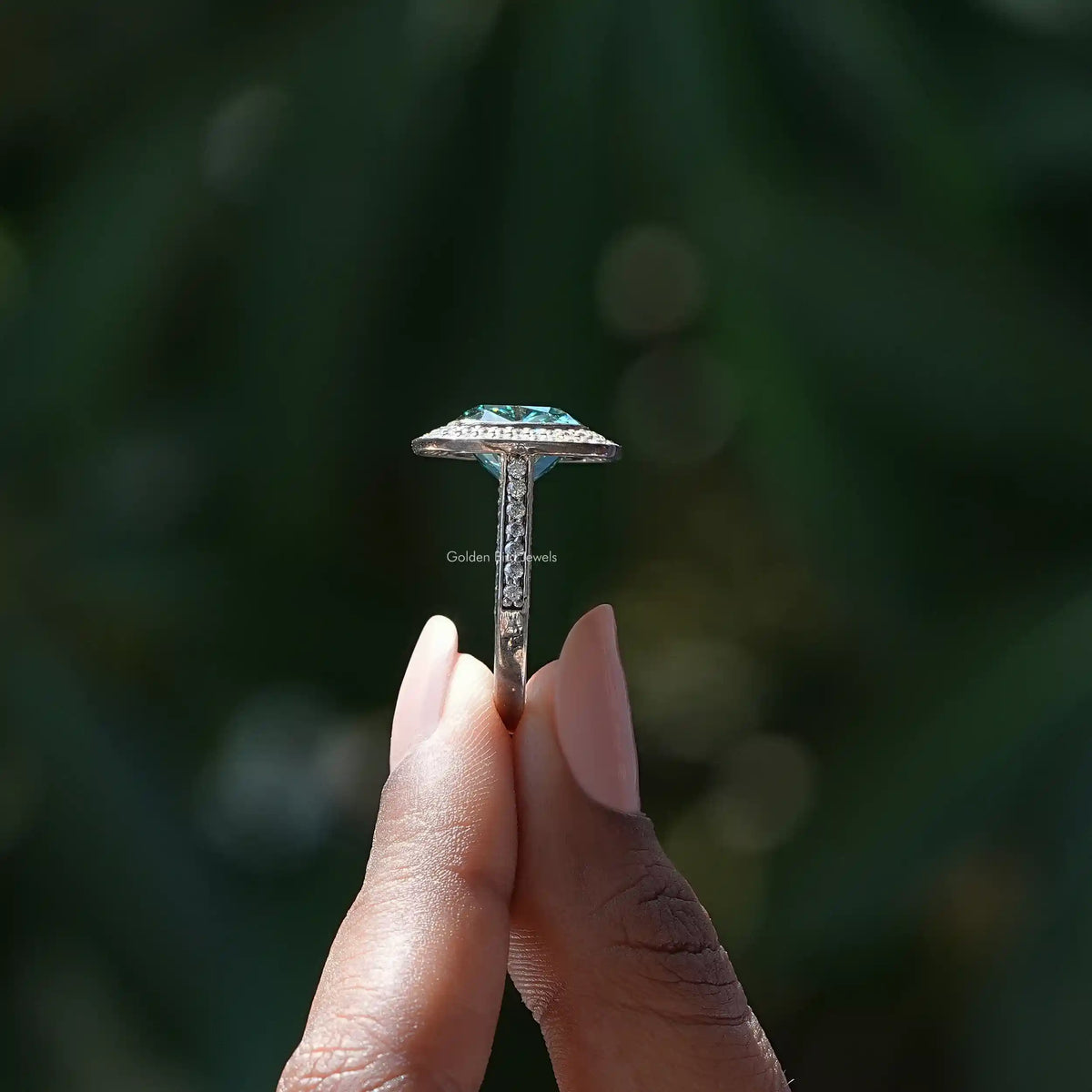 Side View of A Cushion And Round Cut Moissanite Double Halo Ring In two fingers