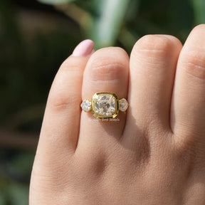 [In hand front view of old mine cushion cut moissanite ring made of round cut side stones]-[Golden Bird Jewels]