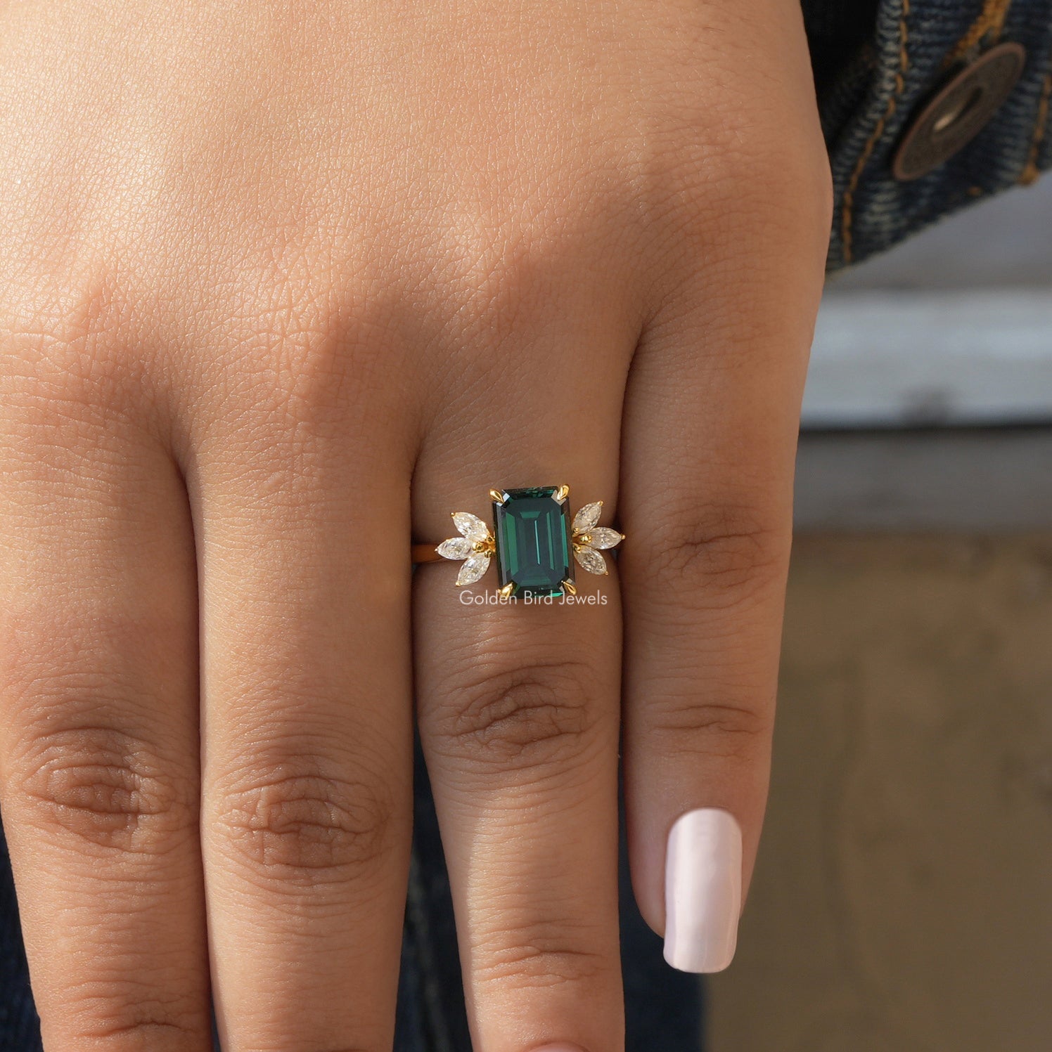 [In finger front view of dark green emerald cut moissanite ring crafted with 14k yellow gold]-[Golden Bird Jewels]