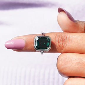 In finger front View of Emerald Cut Bezel Set Moissanite Ring