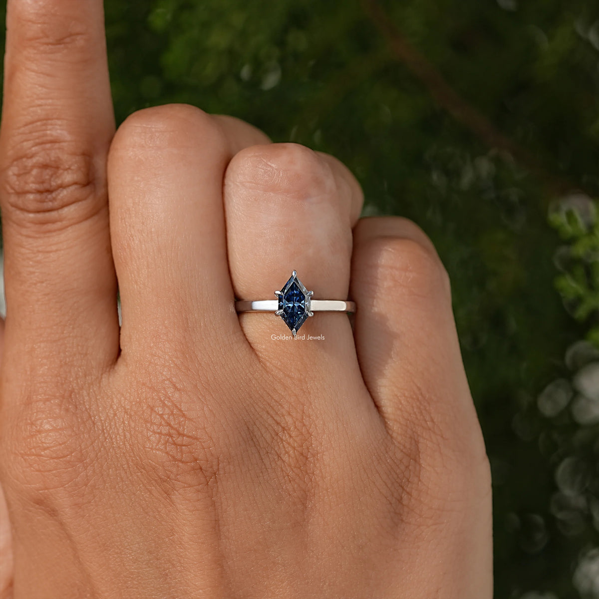 Blue marquise-cut center stone ring on slim silver band