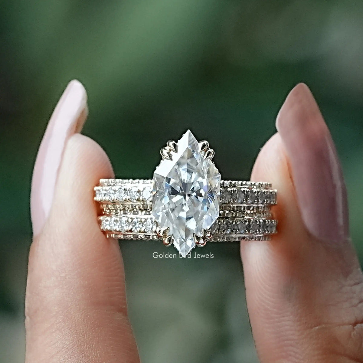 Two fingers holding the Dutch Marquise Cut Moissanite Bridal Ring Set
