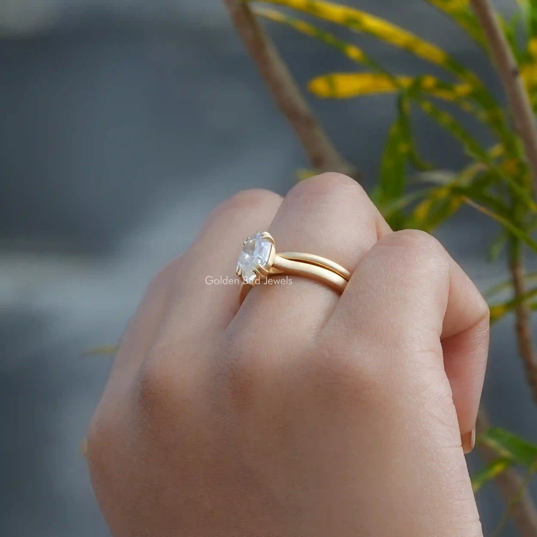 [In finger side view of moissanite dutch marquise cut bridal ring set crafted with 14k yellow gold]