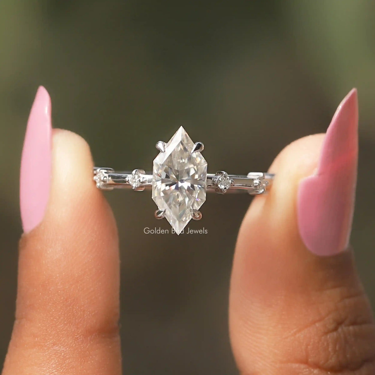 Front View A Dutch Marquise Cut Half Eternity Engagement Ring in two fingers
