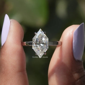 Two fingers holding the Dutch Marquise Cut Moissanite Halo Ring