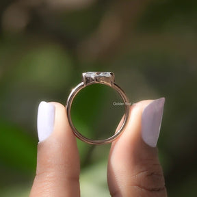 Back View of Moissanite Marquise Cut Solitaire Ring In two fingers