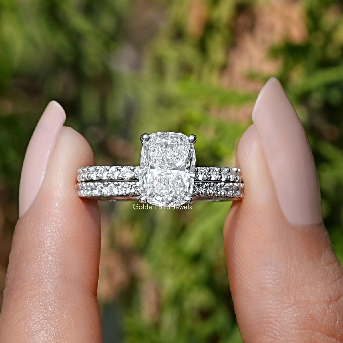 Elongated Cushion Cut Lab Grown Diamond Ring held between two fingers