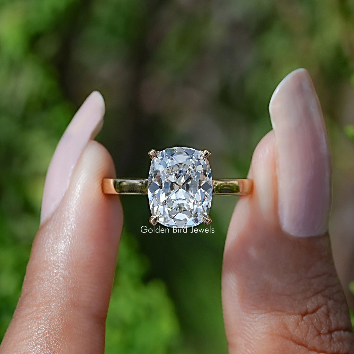 Front View of Elongated Old Cushion Cut Yellow Gold Ring In two Fingers