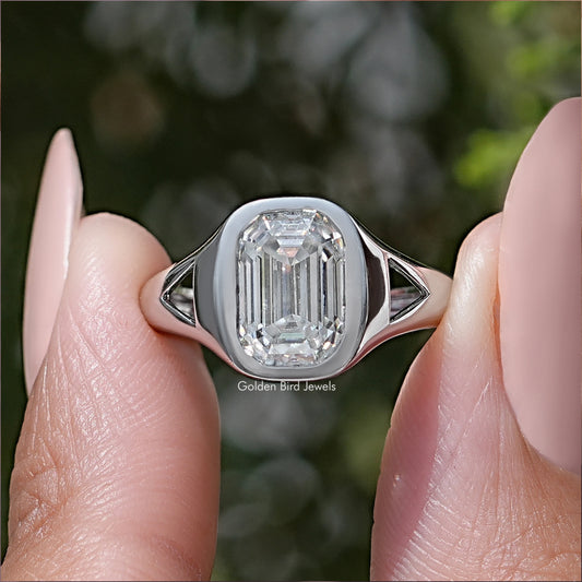 Emerald-cut moissanite bezel-set engagement ring with split shoulders, silver-tone