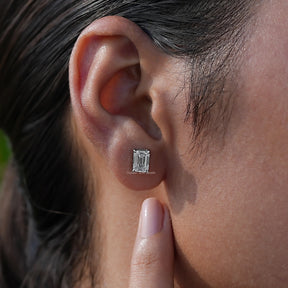 Emerald cut diamond stud earrings in white gold 