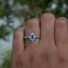 Close-Up View of Emerald Cut Halo Engagement Ring In White Gold