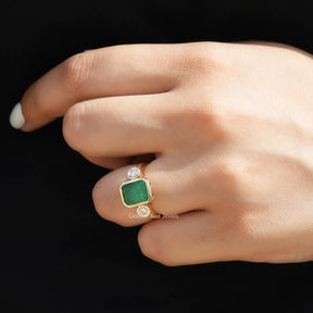 Detailed View Of Emerald And Round Cut Moissanite Ring In Yellow Gold