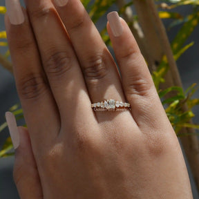 [In finger view of emerald cut moissanite eternity band crafted with side stones]-[Golden Bird Jewels]