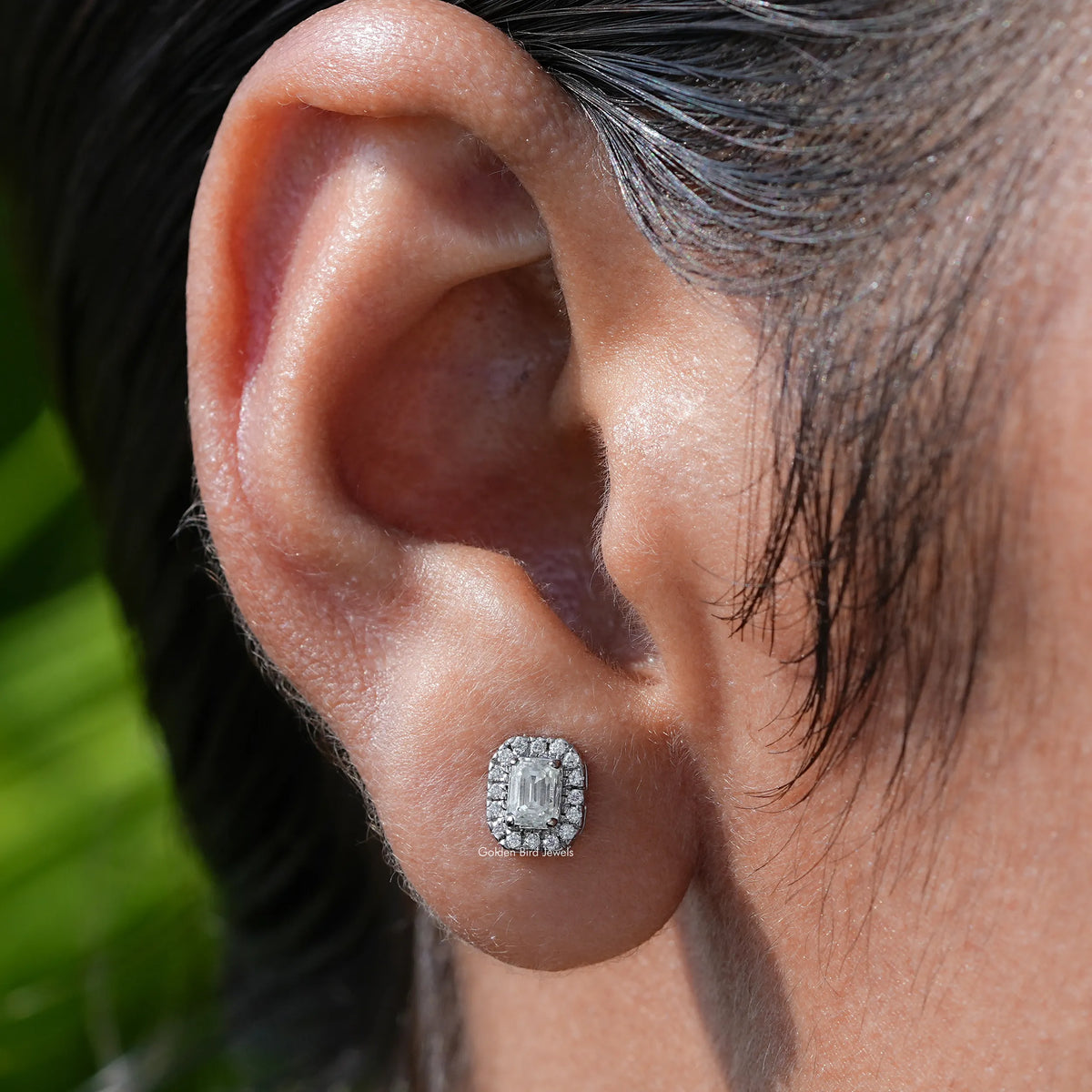 In ear view of moissanite emerald Cut Stud Earrings