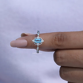 In finger front View of Emerald Cut London Blue Topaz Gemstone Ring In White Gold