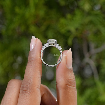 Sterling silver ring viewed from the side, showing the elevated center stone and baguette accents