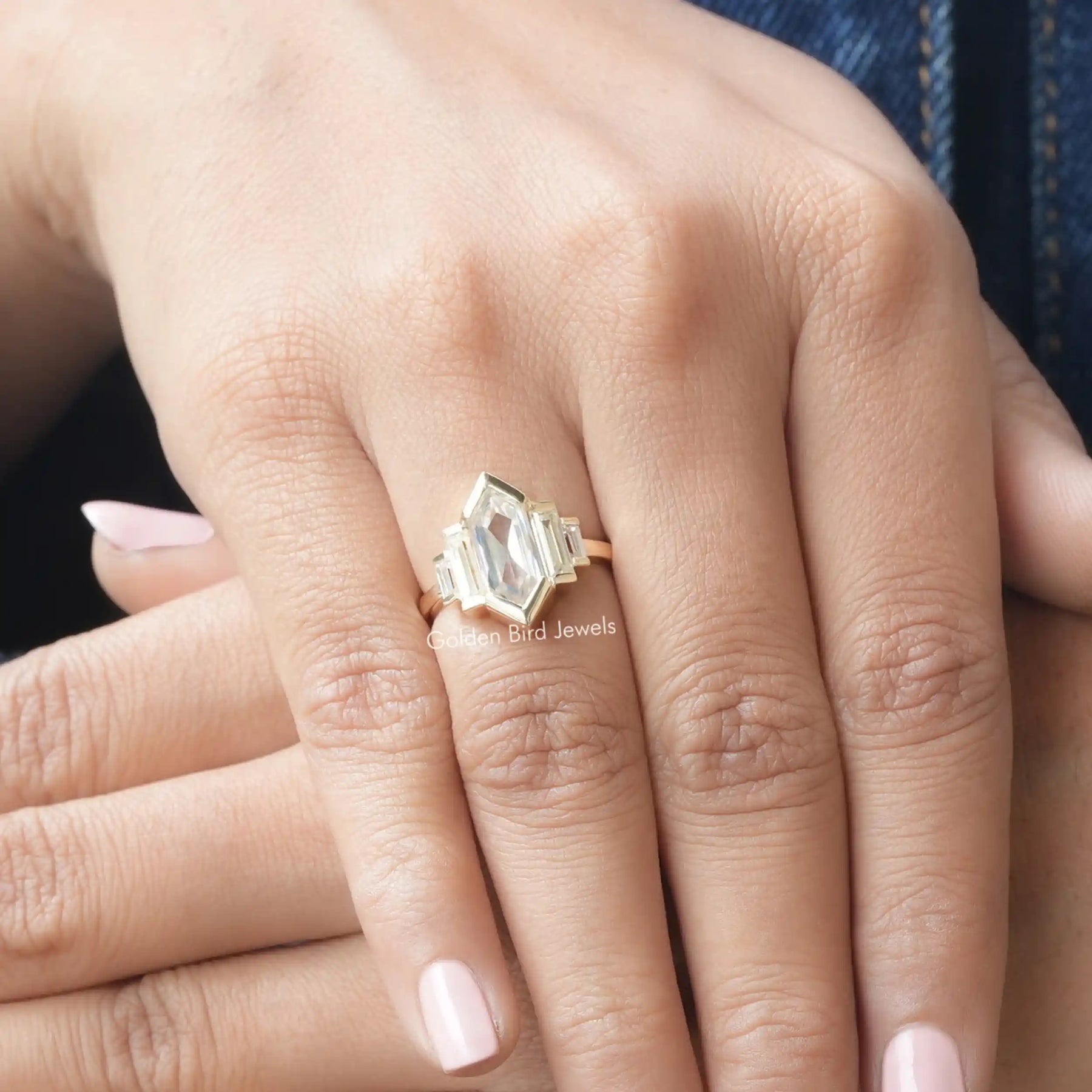 [In finger front view of hexagon baguette cut five stone engagement ring in 14k yellow gold]-[Golden Bird Jewels]