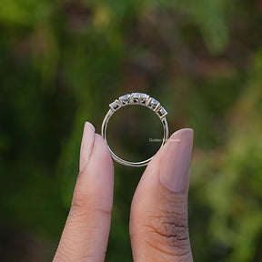 Back View of Five Stone Octagon And Round Cut Diamond Ring In two fingers
