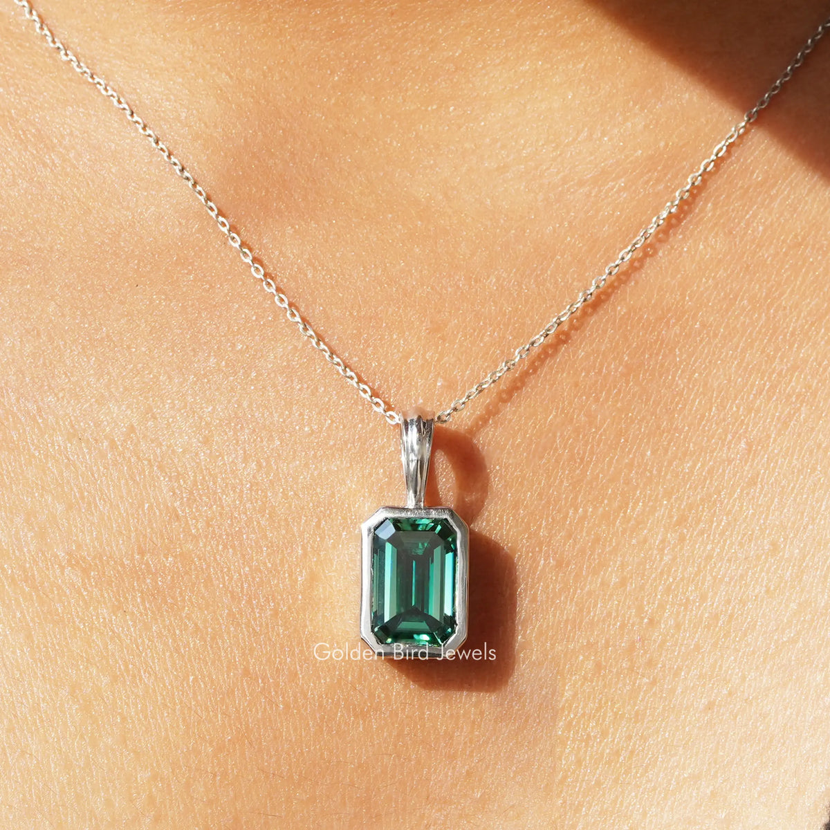 Green emerald-cut moissanite solitaire pendant