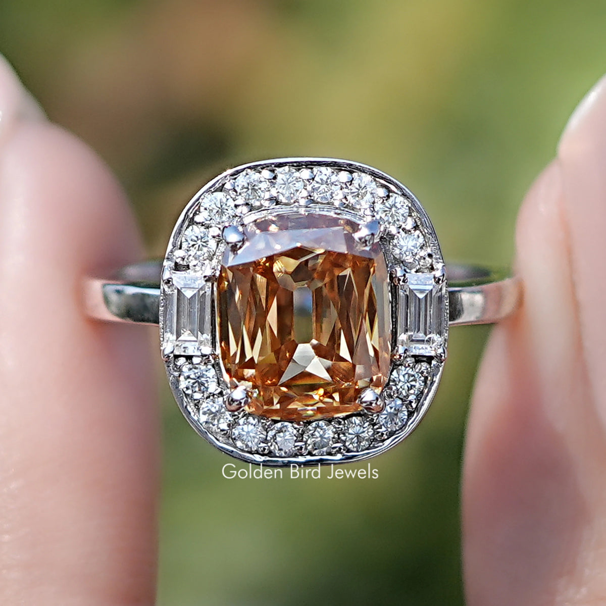 Front view of Criss Cut Cushion Moissanite Halo Engagement Ring in two fingers 