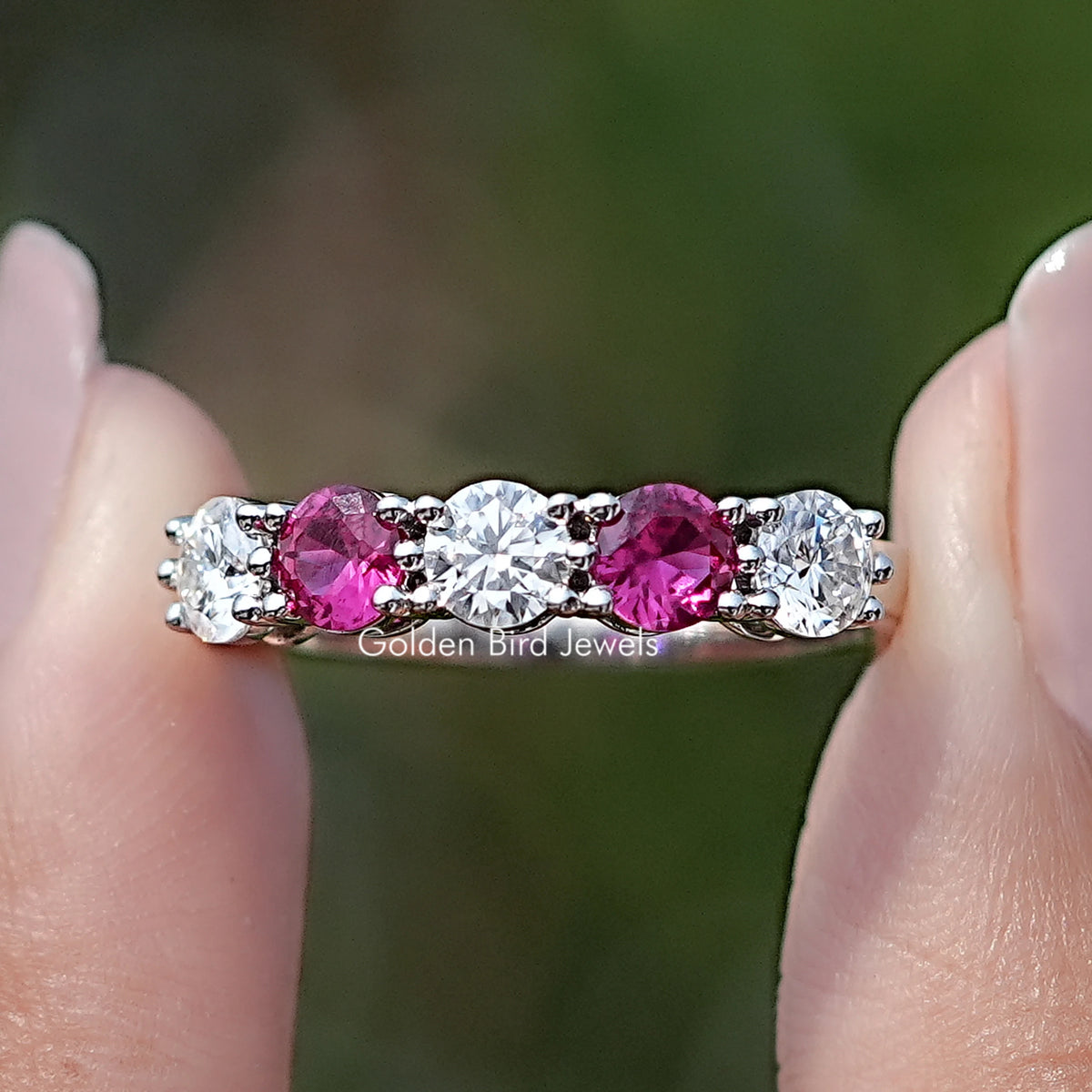 Front view of Five Stone Round Gemstone Wedding Band in two fingers 
