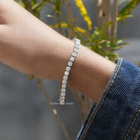 In hand view of round cut moissanite halo bracelet 