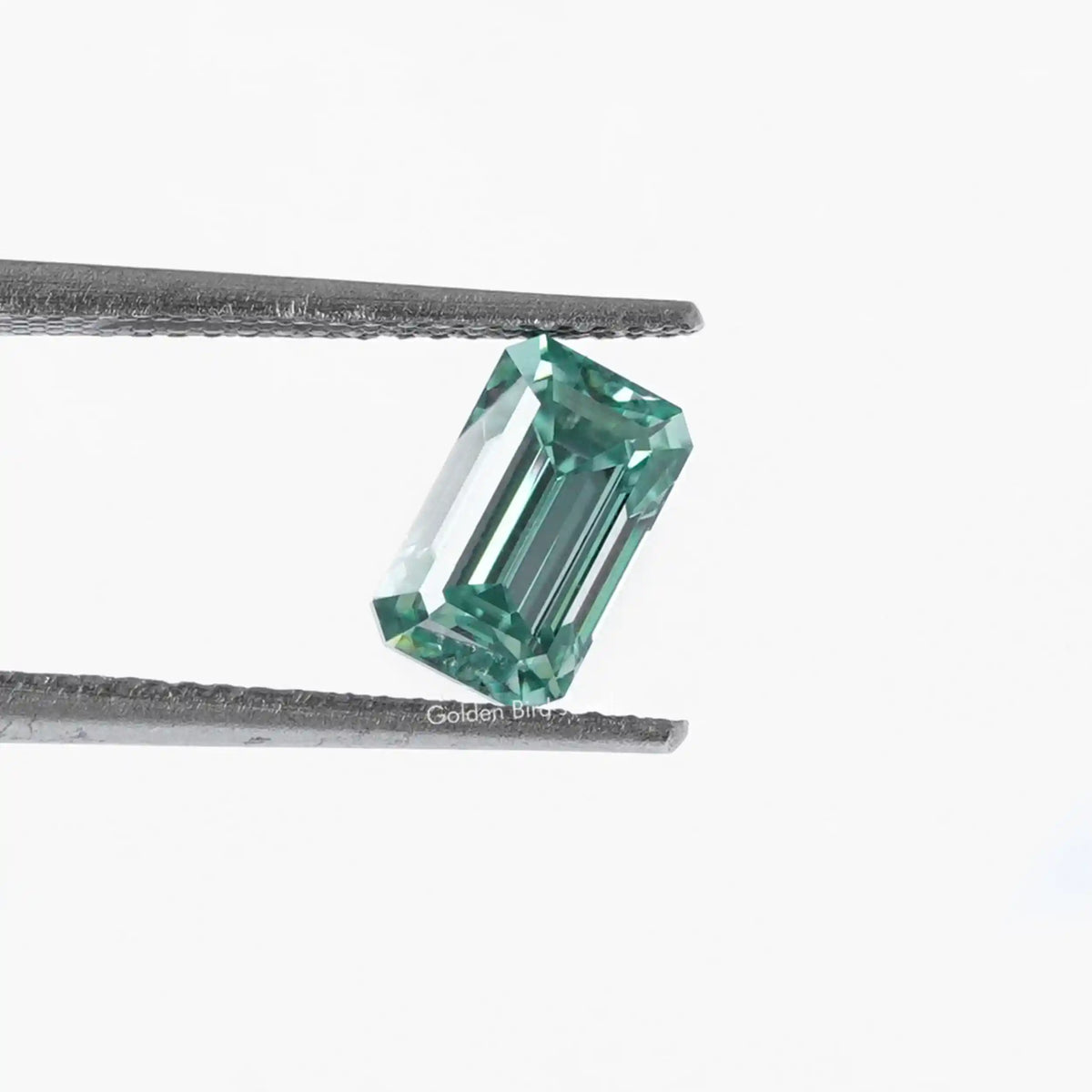 [In twizzer front view of blue emerald cut loose moissanite]-[Golden Bird Jewels]