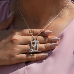 In hand showing view of moissanite pendant	 		