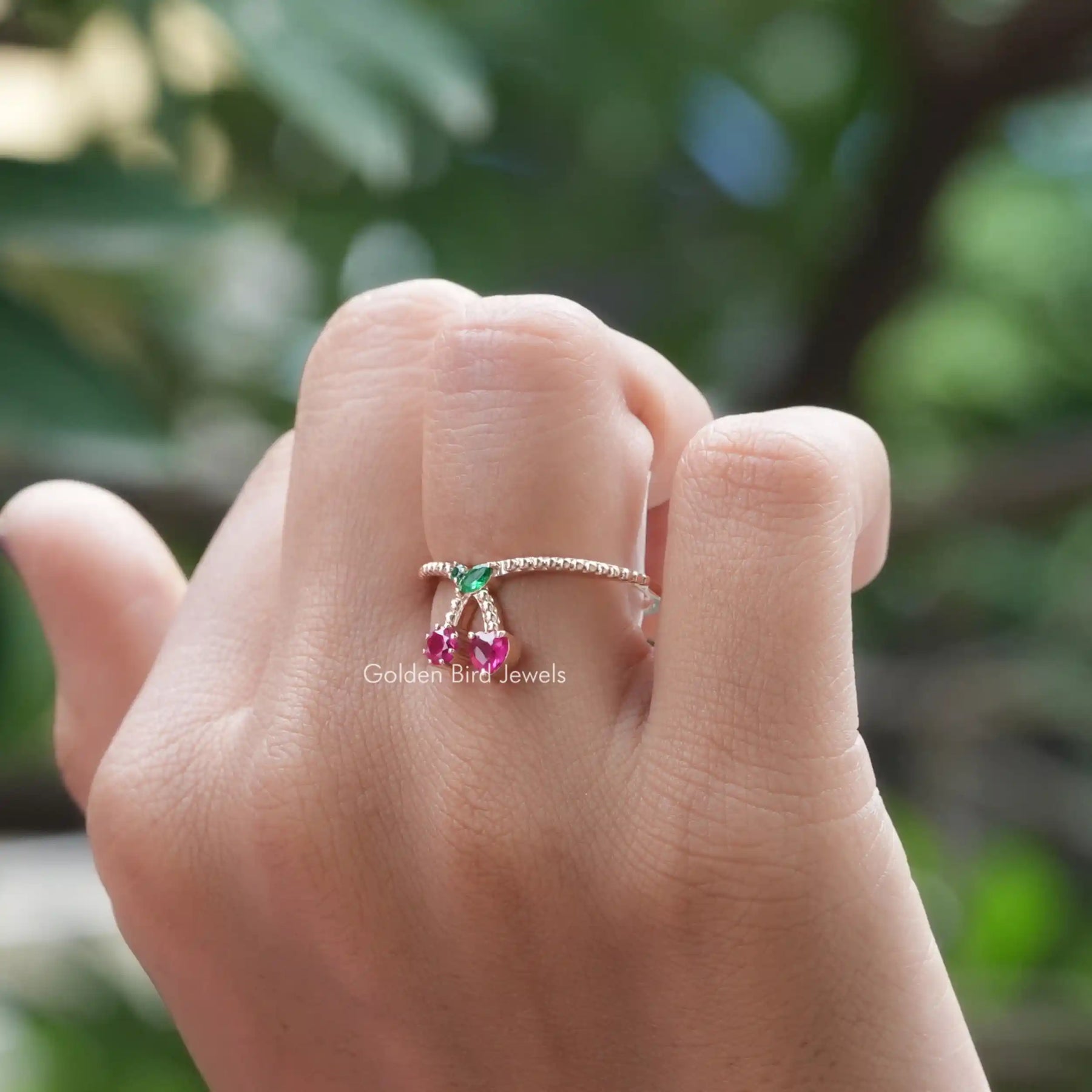 [In finger front view of multi stone ring made of vs clarity and red heart and round cut gemstones]-[Golden Bird Jewels]